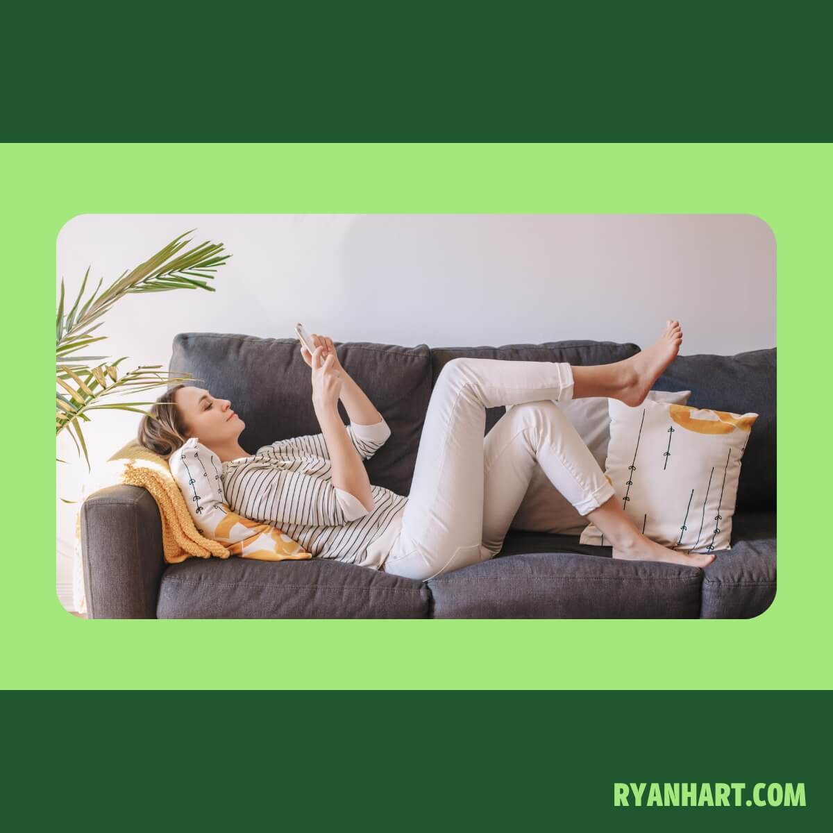 Woman sitting on couch looking at phone