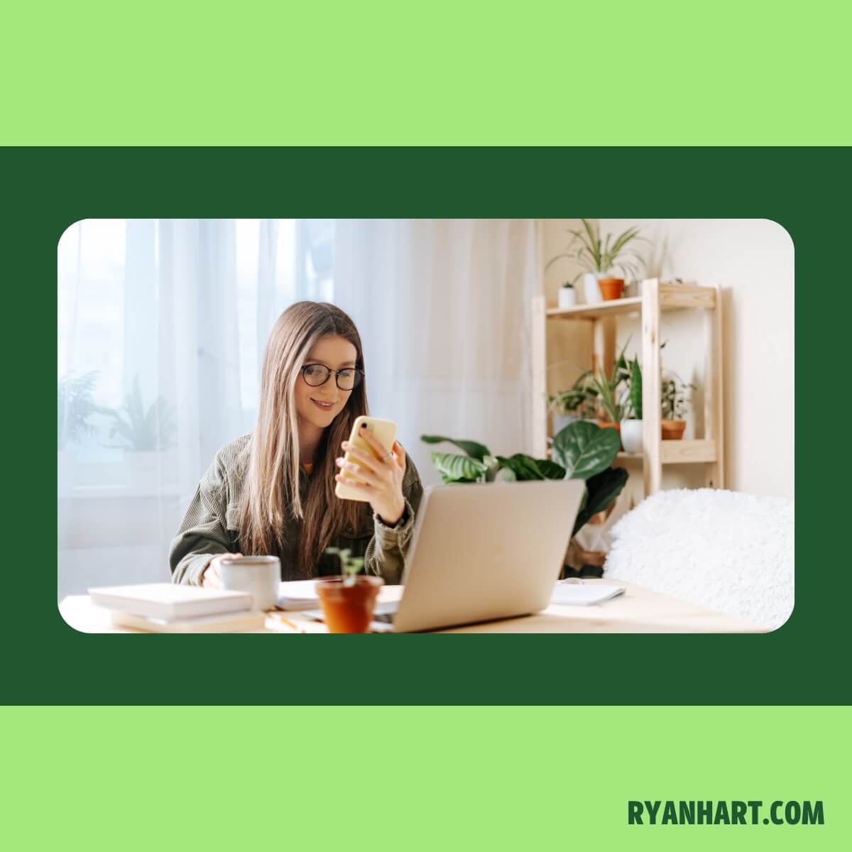 Woman sitting at desk looking at phone