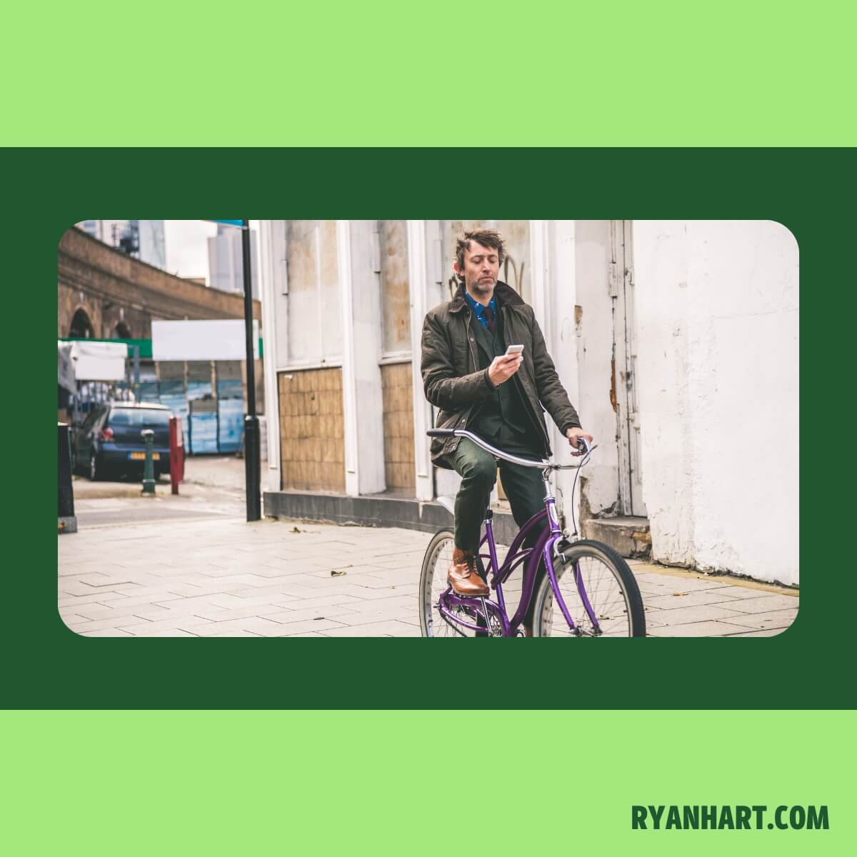 Man riding bike while looking at phone