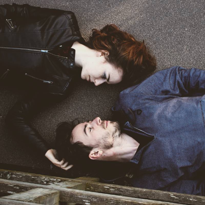 Man and Woman Lying on Ground