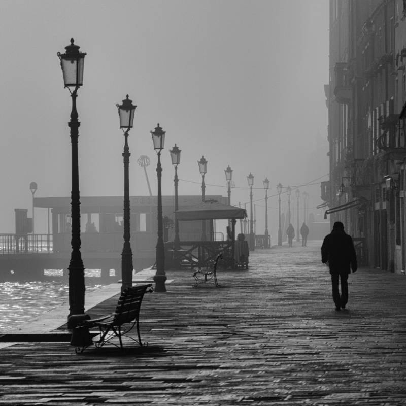 Man Walking on Sidewalk Alone