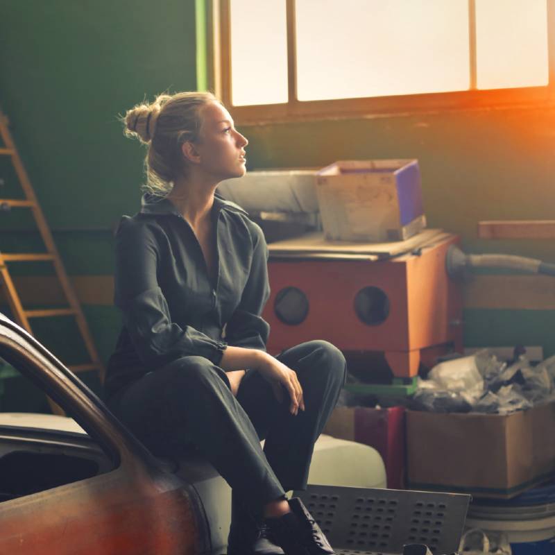 Woman sitting in garage