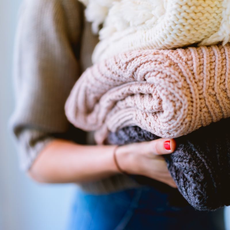 Woman Carrying Blankets